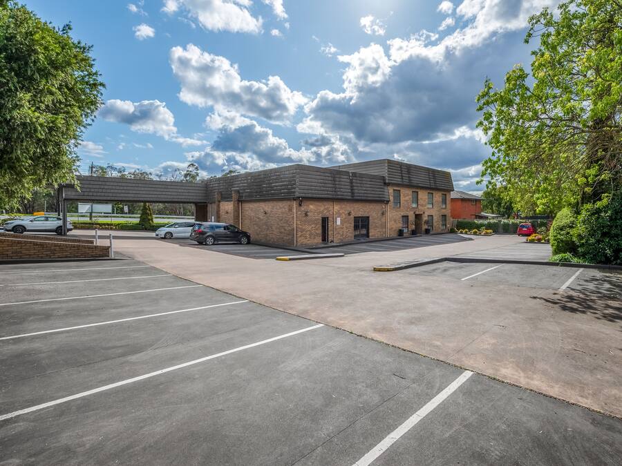 A parking lot with a building in the background.