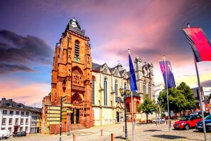 A historic building with intricate architecture, a prominent tower, and a flagpole with multiple flags. - Best Western Hotel Wetzlar (Wetzlar)