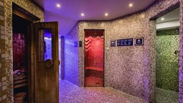 Stylish hallway leading to a room with a unique mosaic tile design and amenities including a shower and sauna.