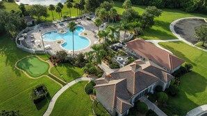 A residential property with a swimming pool, a golf course, and a large house with a tiled roof. - Sheraton PGA Vacation Resort, Port St. Lucie (Port Saint Lucie)