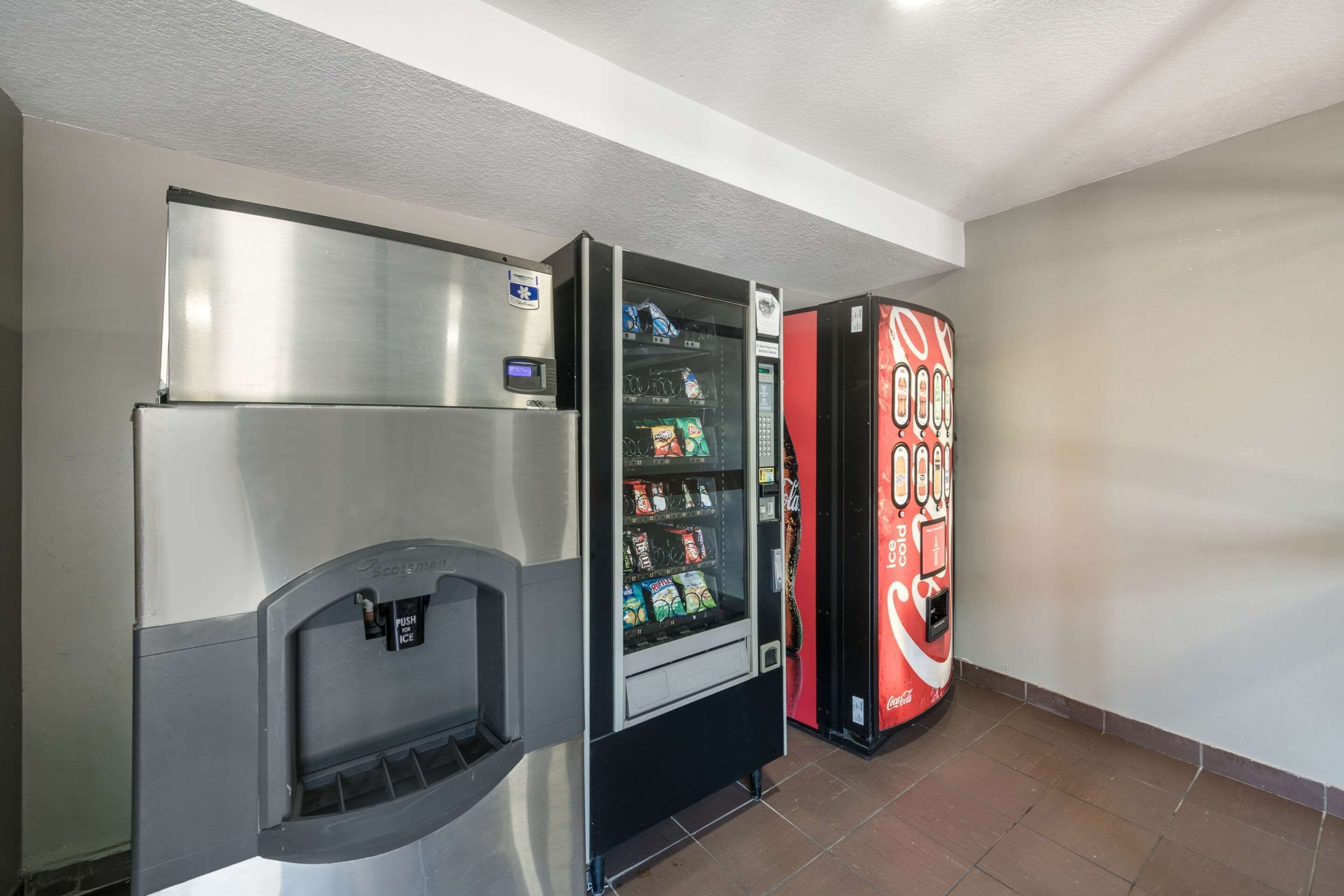 A vending machine area with a water dispenser and a Coca-Cola branded machine.