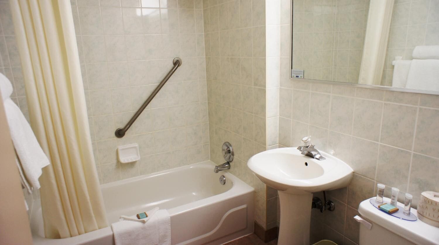 Een badkamer met een bad, een wastafel en een toilet.