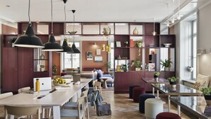 A modern interior with a dining area, seating, and a kitchen. - Stay KooooK Bern City – Online Check In (Bern)
