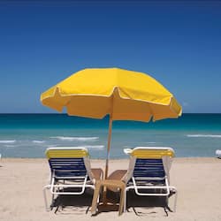 On the beach, white sand, beach cabanas, sun loungers