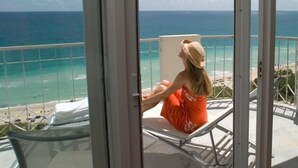 A person sitting on a balcony chair with a view of the ocean. - Sea View Hotel, Bal Harbour, On The Ocean (Bal Harbour)