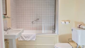 Un baño con bañera, lavamanos e inodoro.