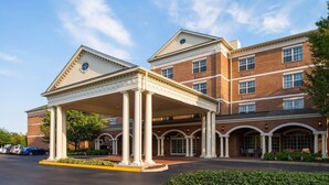 A hotel with a covered entrance, brick facade, and multiple windows. - Springhill Suites by Marriott Williamsburg (Williamsburg)