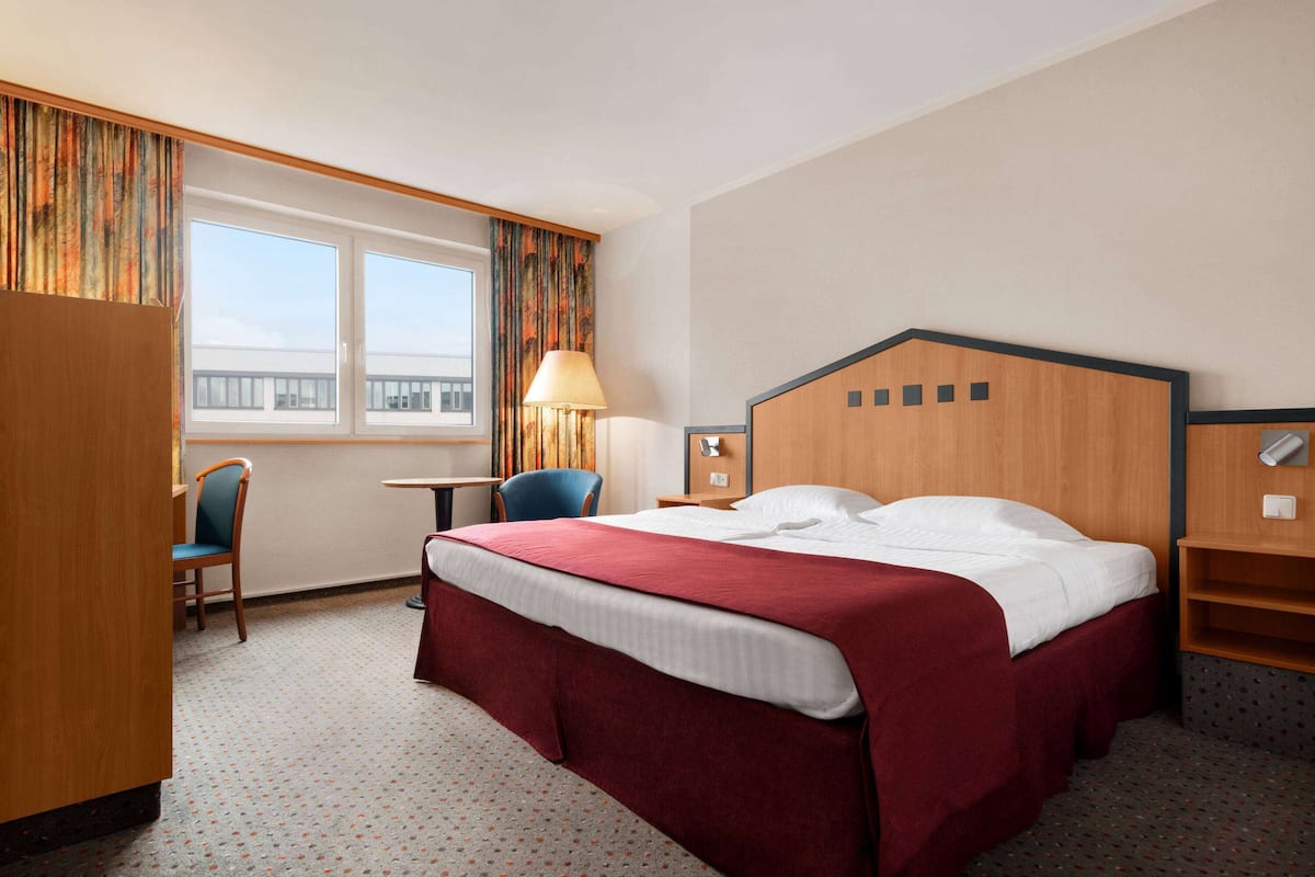 Hypo-allergenic bedding, down duvets, desk, laptop workspace