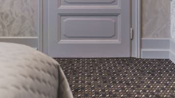 A closed door with a simple handle and a keyhole, set in a room with patterned carpet and textured wallpaper.