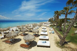 On the beach, sun-loungers, beach umbrellas, beach towels