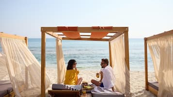On the beach, sun-loungers, beach umbrellas, beach towels