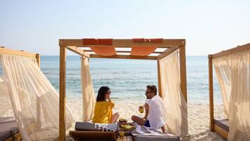 On the beach, sun loungers, beach umbrellas, beach towels