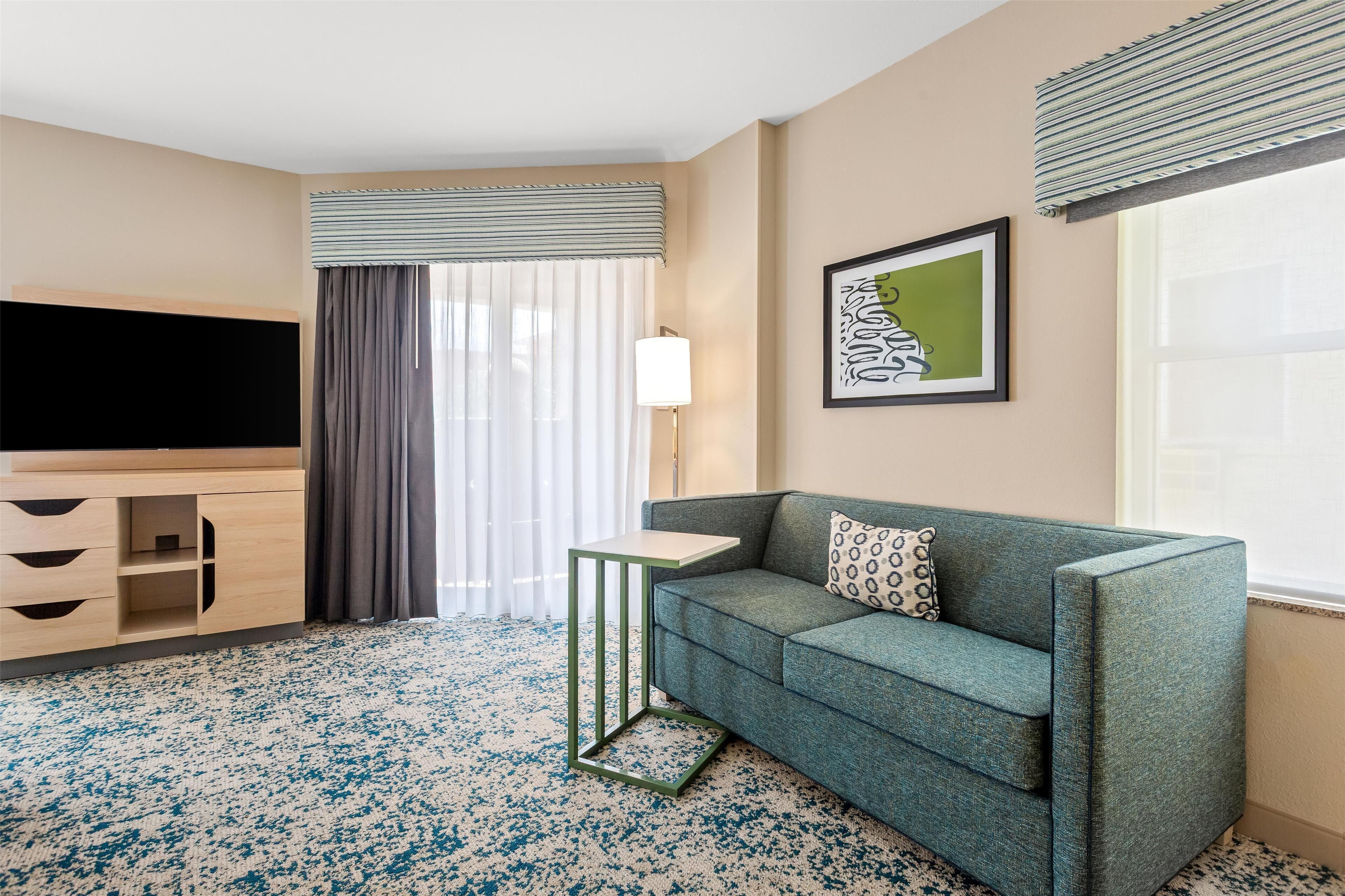 studio suite, 2 queen beds, sofabed with balcony | living area | 0-inch tv with satellite channels, netflix, hulu