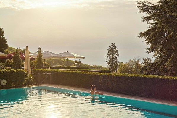 Outdoor pool, open 7:00 AM to 10:00 PM, pool loungers