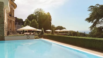 Outdoor pool, open 7:00 AM to 10:00 PM, pool loungers