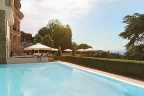 Outdoor pool, open 7:00 AM to 10:00 PM, pool loungers