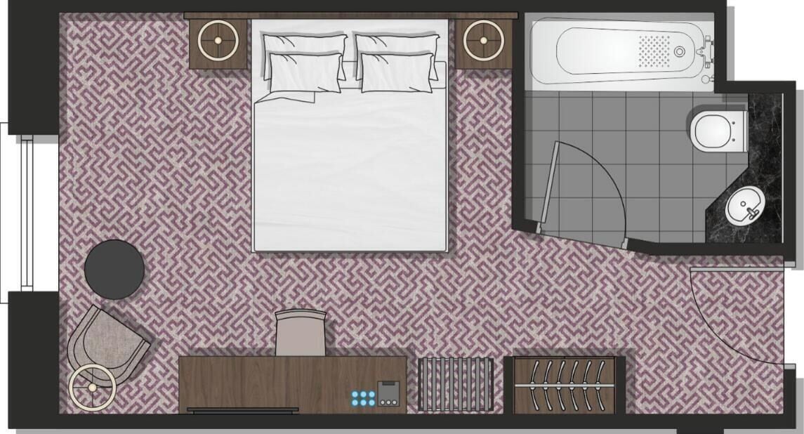Un dormitorio con cama, un baño con bañera y una zona de estar con una silla y una mesa.