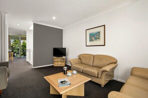 Standard Two Bedroom Apartment | Living area | Flat-screen TV