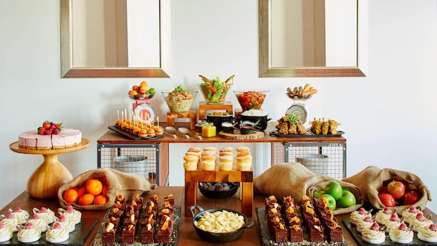 A buffet table with various food items and desserts. - Delta Hotels Bexleyheath (Bexleyheath)