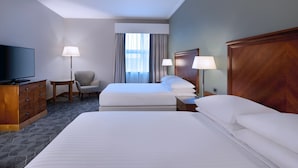 A hotel room with a large bed, a TV, a desk, and a chair. - Delta Hotels Bexleyheath (Bexleyheath)