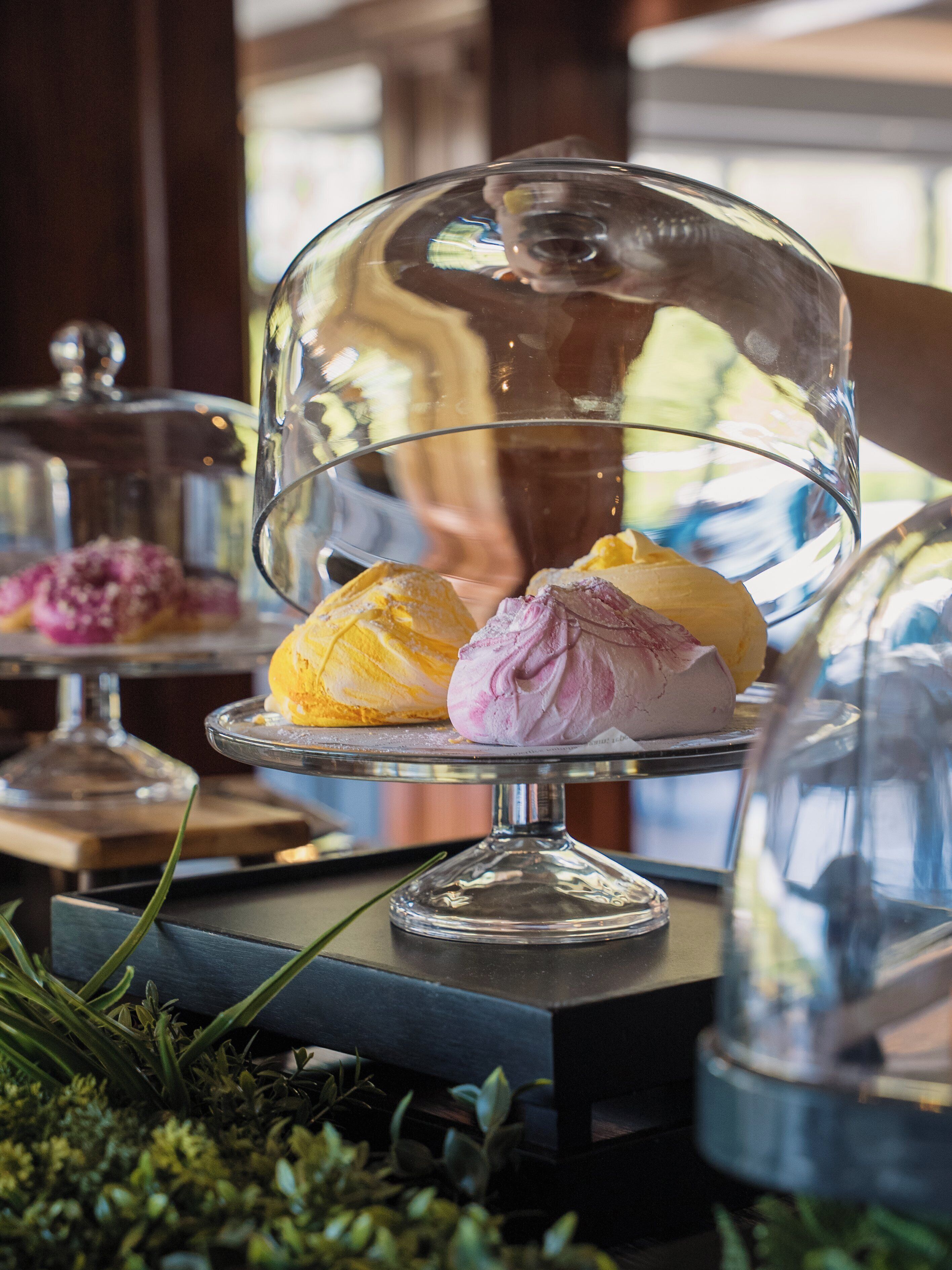 A dessert display with a glass dome cover.