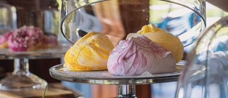 A dessert display with a glass dome cover.