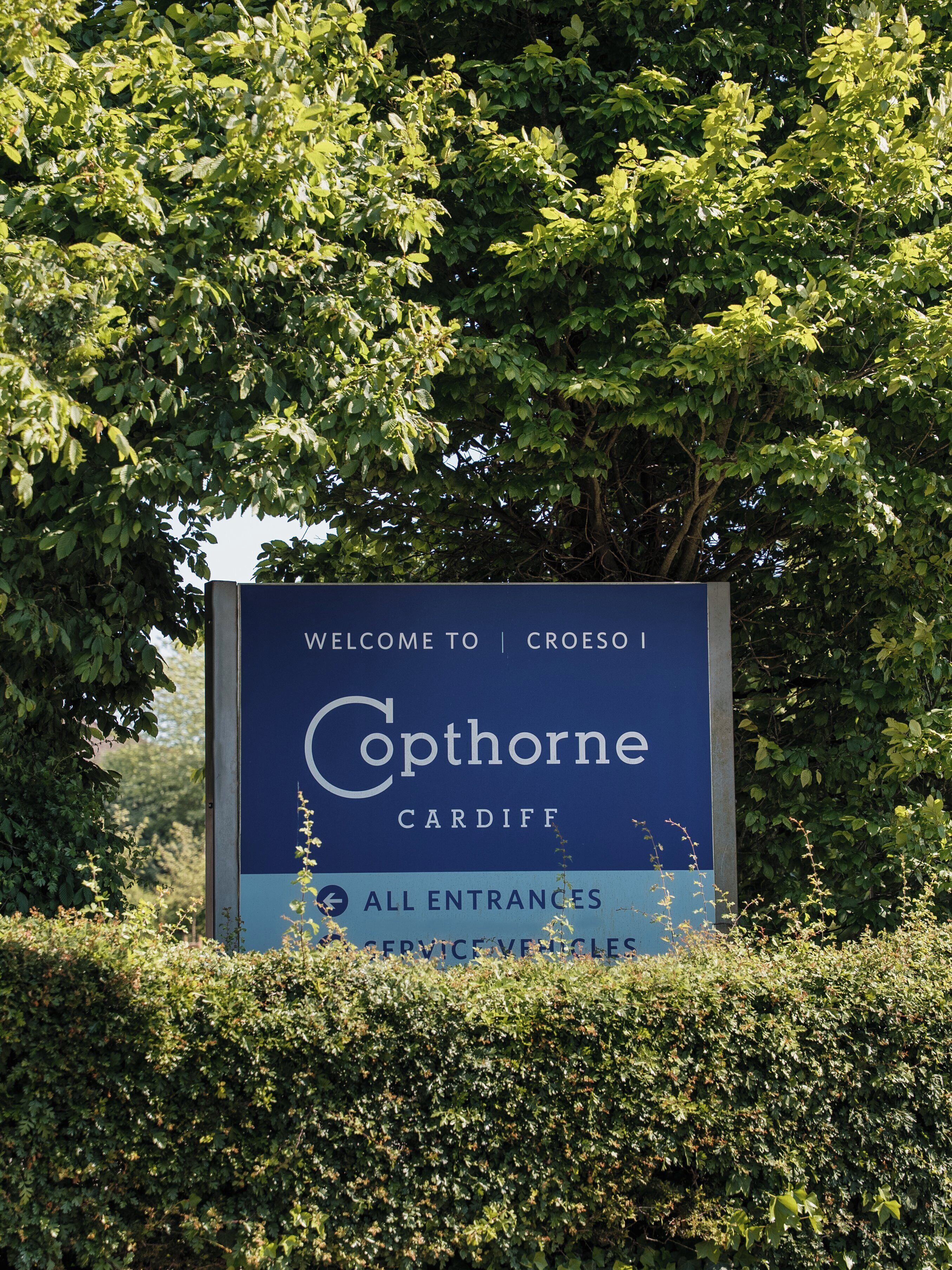 A welcome sign for Caphorne in Cardiff, indicating all entrances and service vehicles.