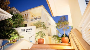 A hotel entrance with a sign reading "The Seibel Laguna on Hastings." - The Sebel Noosa (Noosa Heads)