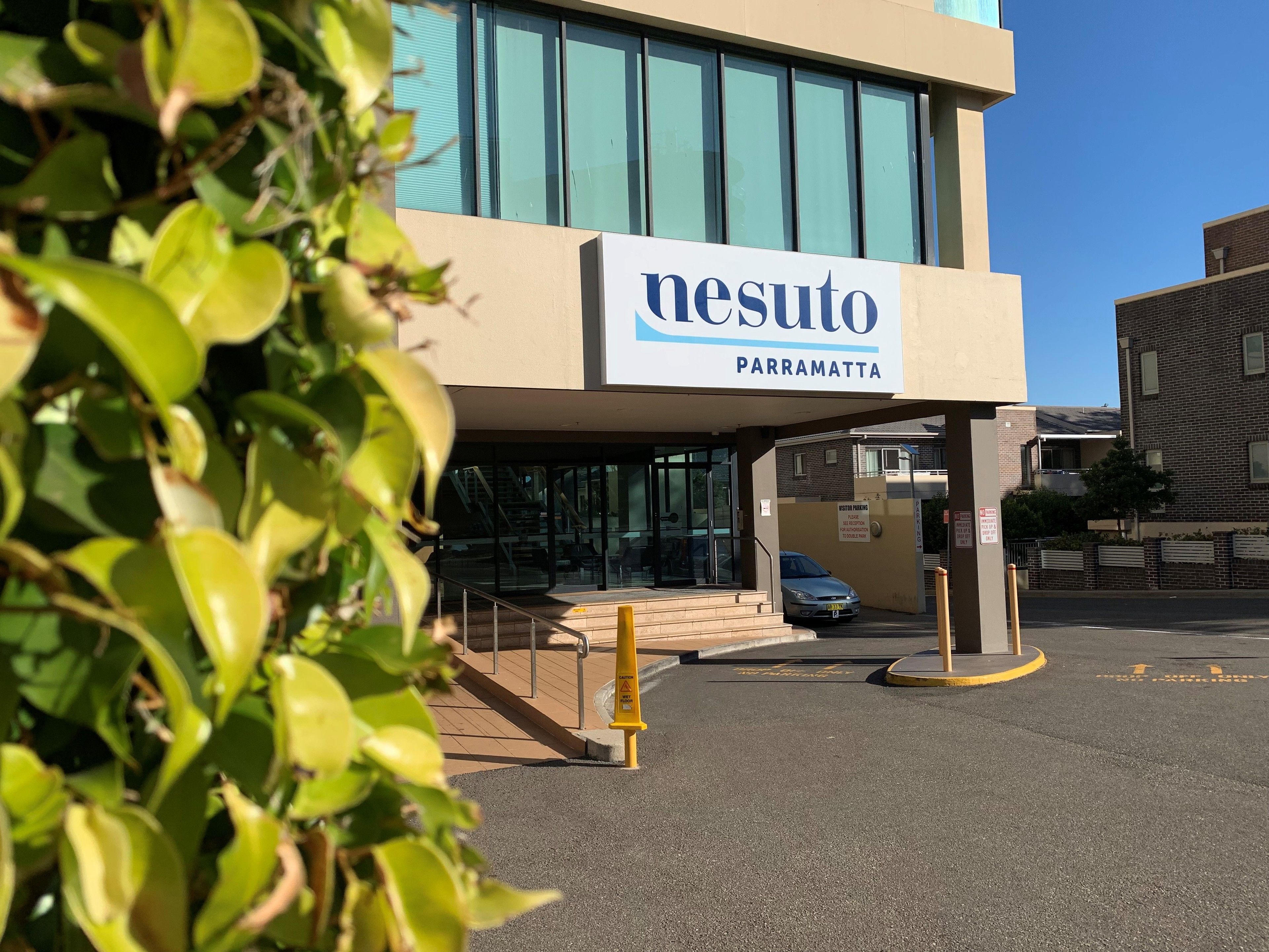 A building with a sign reading "nesuto parramatta".