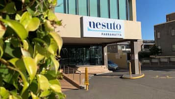 A building with a sign reading "nesuto parramatta".