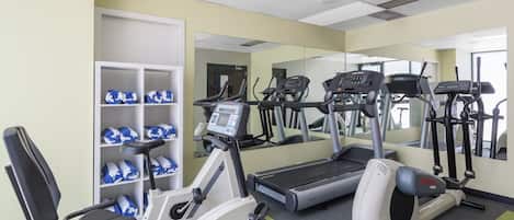 A gym with treadmills, an elliptical, and a stationary bike.