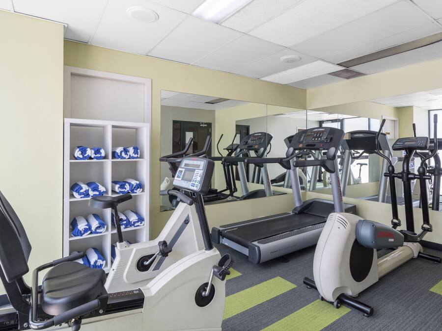 A gym with treadmills, an elliptical, and a stationary bike.