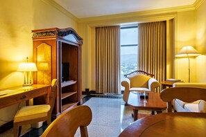 Ambassador Suite | Living area | 32-inch flat-screen TV with cable channels, TV
