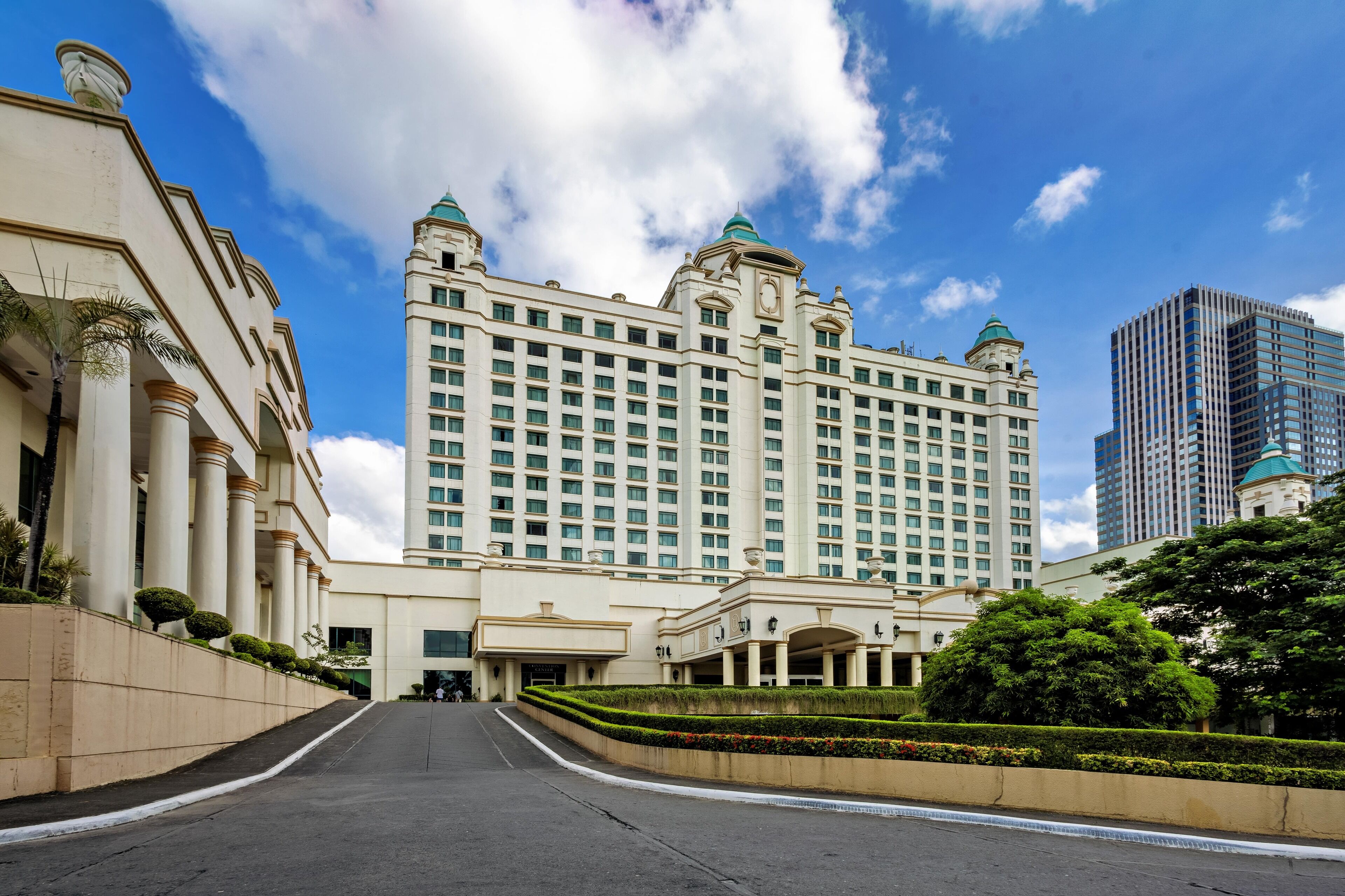 A large hotel with a grand entrance, multiple floors, and a prominent clock tower.