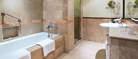 A modern bathroom with a bathtub, a shower, and a sink.
