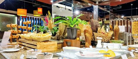 A buffet setup with various food items and dishes.