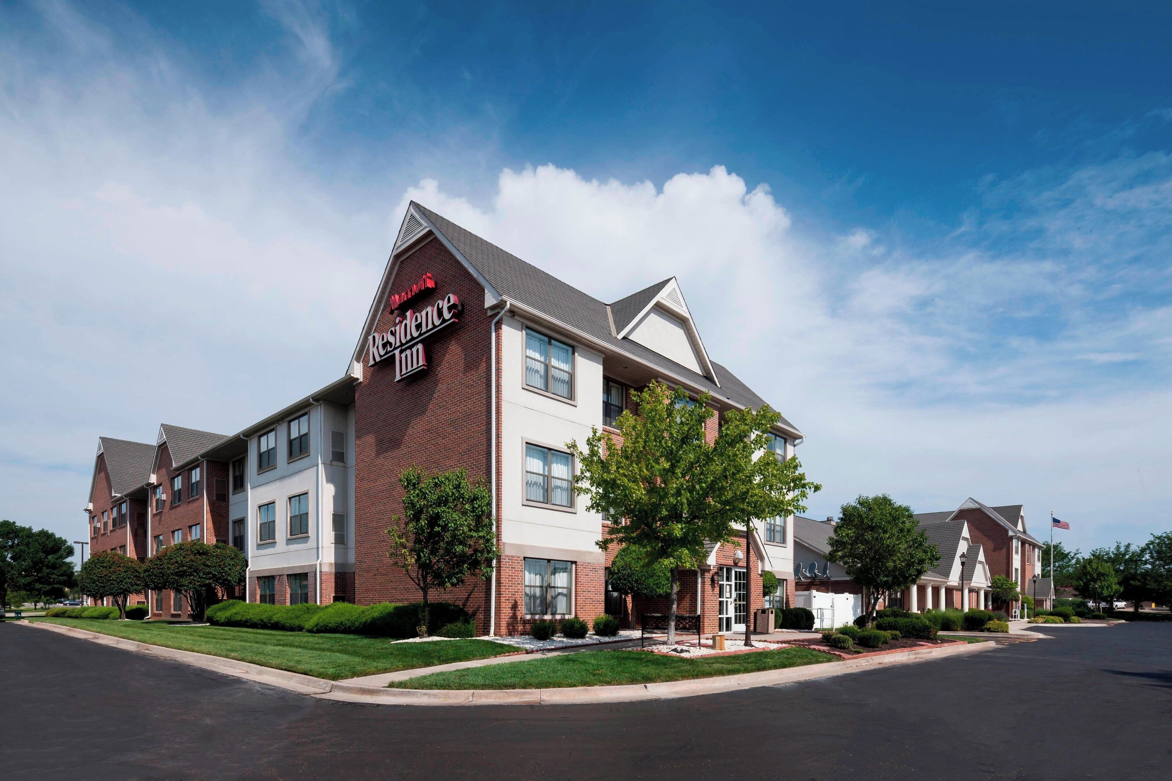 A brick building with a sign for the Residence Inn hotel.