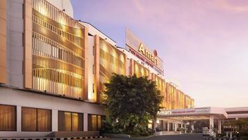 A modern building with a large sign reading "Amari Don Muang Airport Bangkok".