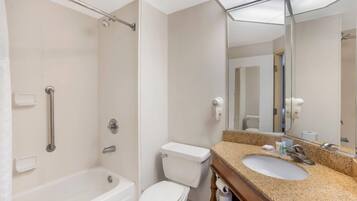 A modern bathroom with a bathtub, toilet, and sink.