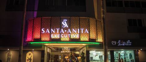 A hotel with a large illuminated sign reading "SANTA ANITA EXECUTIVE".