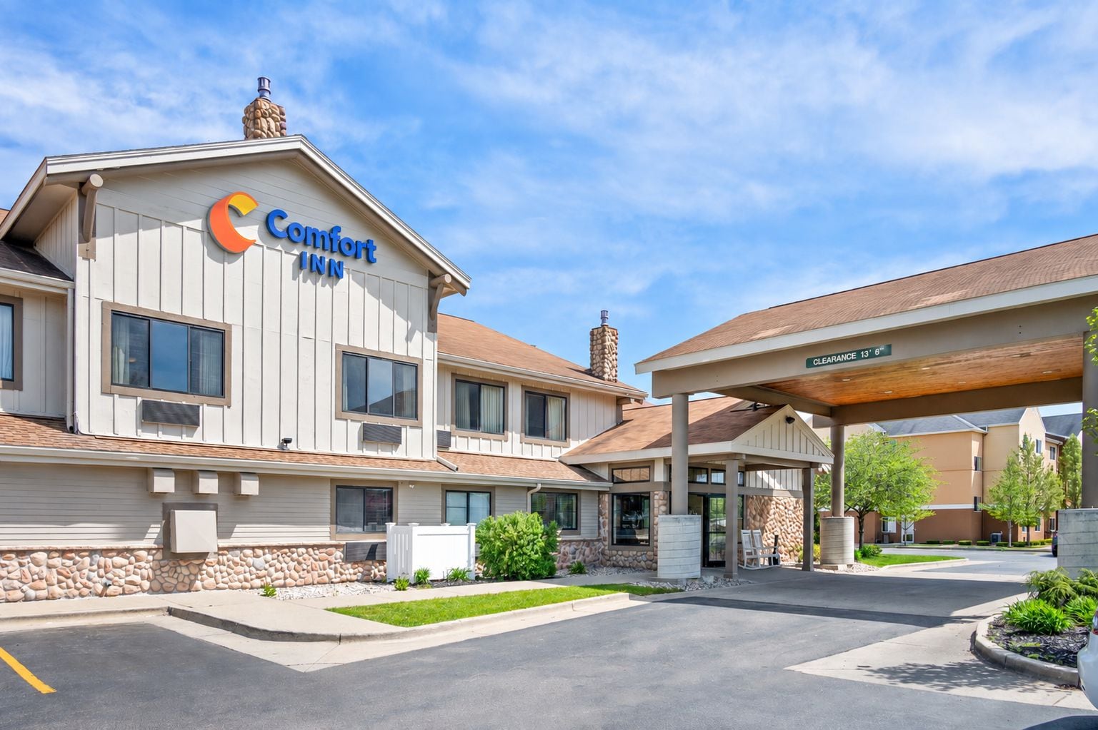 A Comfort Inn hotel with a covered entrance and a stone facade.