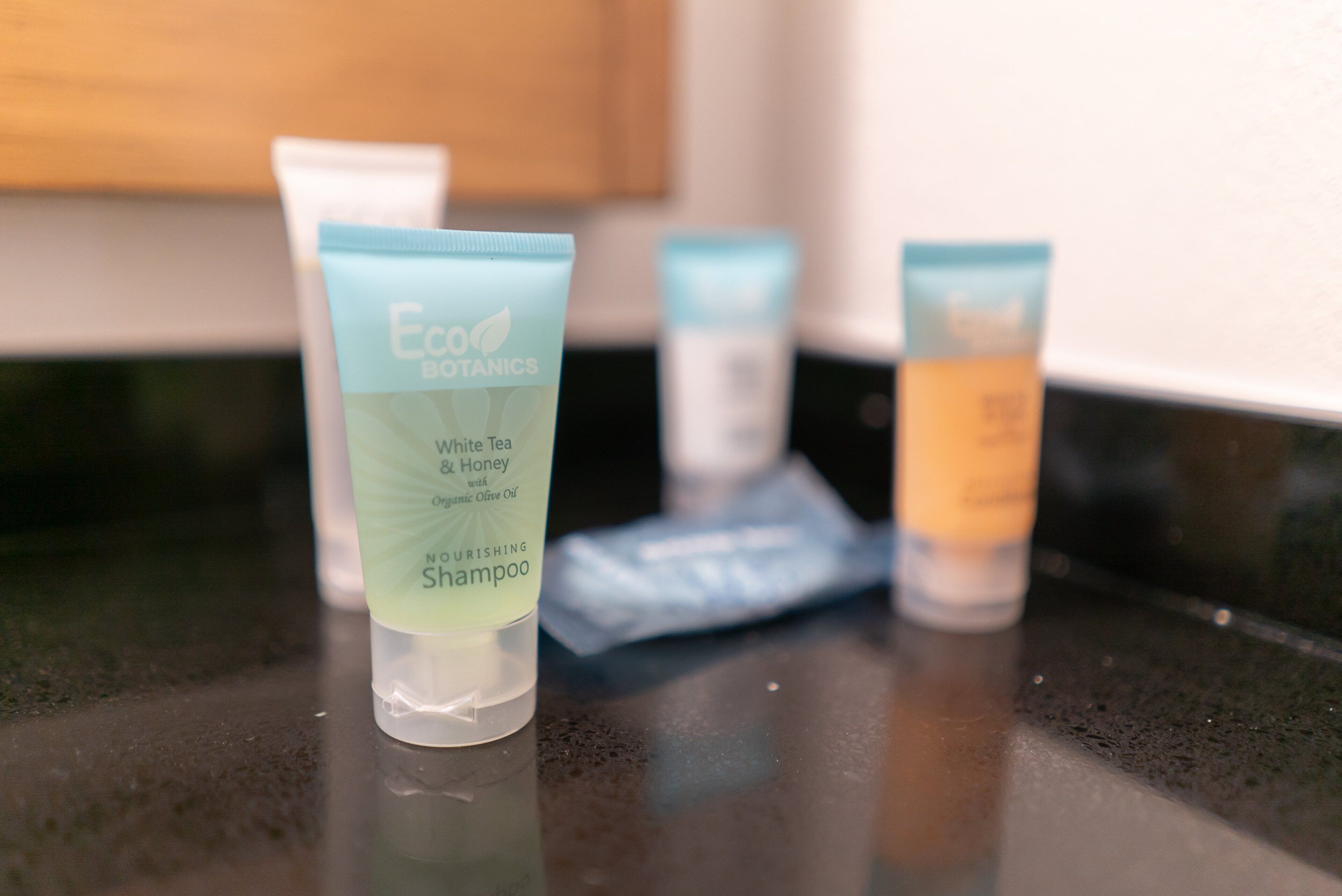A countertop with three tubes of Eco Botanics shampoo.