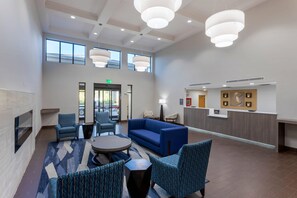 A spacious lobby with a reception desk, seating area, and large windows. - Comfort Inn & Suites Hot Springs Midtown (Hot Springs)