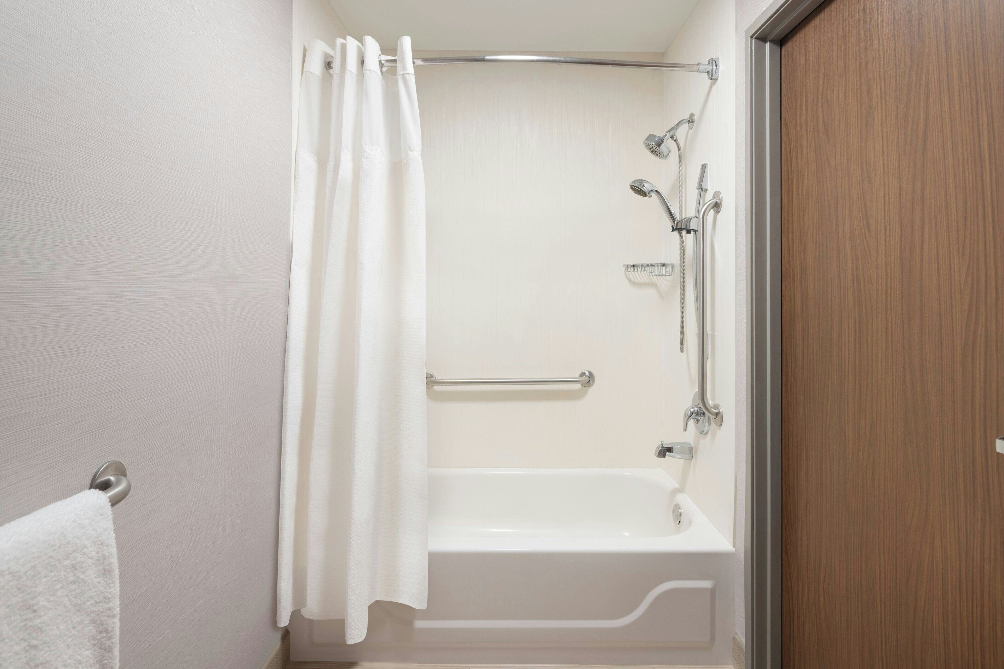 A bathroom with a bathtub, a shower, and a toilet.