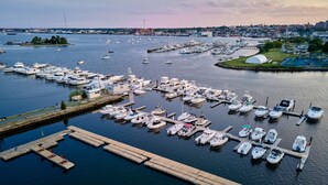 A marina with numerous boats docked at wooden piers. - Seaport Resort & Marina (Fairhaven)