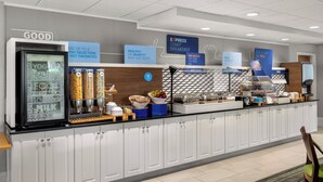 A breakfast bar with various food options, including yogurt, milk, and hot food. - Holiday Inn Express & Suites New Buffalo by IHG (New Buffalo)