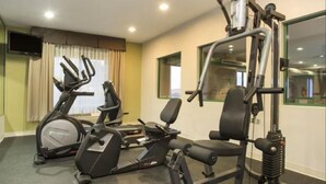 A gym with cardio equipment, weight machines, and a mirror. - Sleep Inn & Suites Kalamazoo East (Kalamazoo)