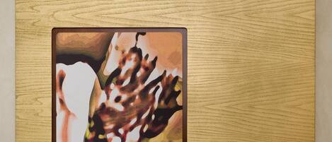 A framed artwork on a wooden surface.