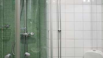 A bathroom with a shower, toilet, and sink.