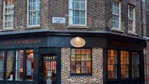 A brick building with a sign for 'PETER'S LANE E.C.1' and 'THE ROOKERY 1764'. - The Rookery Hotel (London)